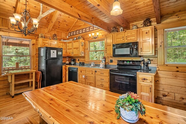 kitchen with sink, black appliances, beam ceiling, a notable chandelier, and hanging light fixtures