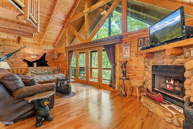 living room featuring high vaulted ceiling, a fireplace, beamed ceiling, wood-type flooring, and wood ceiling