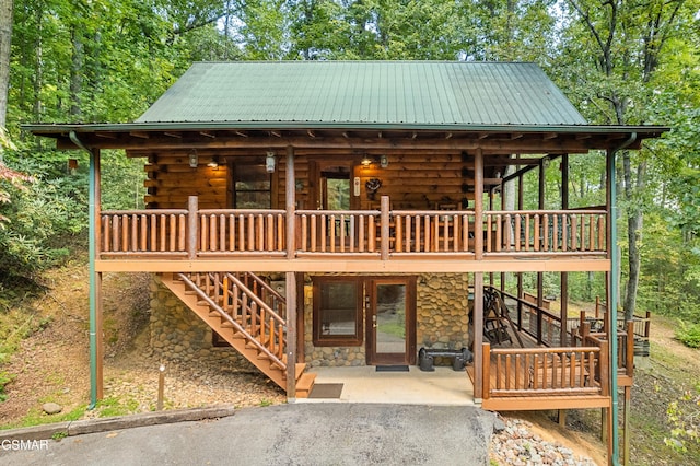 view of front of home with a patio and a wooden deck