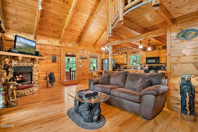 living room featuring beam ceiling, light wood-type flooring, wood walls, and wood ceiling