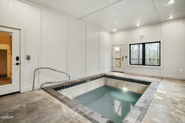 view of pool with an indoor hot tub