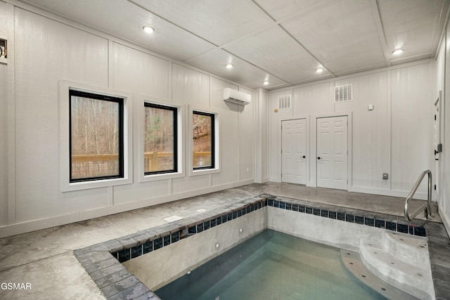 view of swimming pool with a wall mounted air conditioner and an indoor hot tub