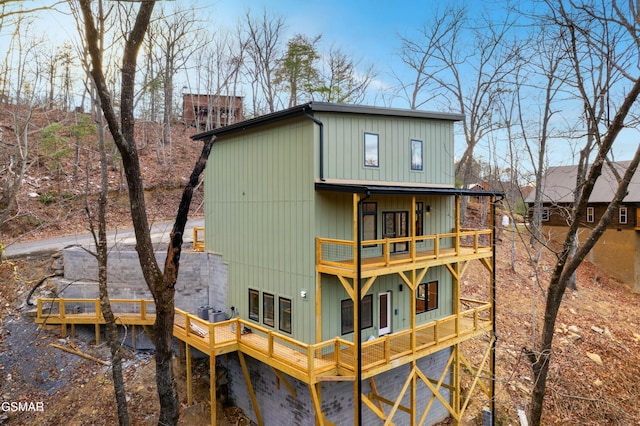 rear view of property with a balcony