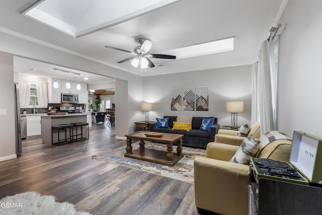 2887 Pine Haven Dr, Sevierville, TN 37862 - living room featuring dark wood finished floors, ornamental molding, ceiling fan, and baseboards