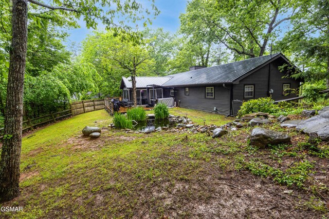 2887 Pine Haven Dr, Sevierville, TN 37862 - rear view of property with fence, metal roof, and a sunroom