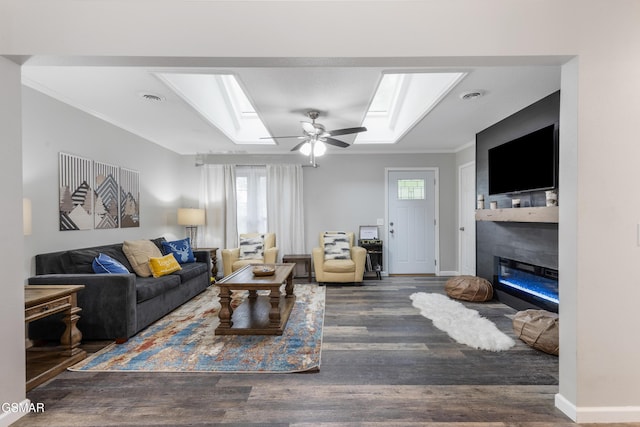 2887 Pine Haven Dr, Sevierville, TN 37862 - living room with a skylight, crown molding, a glass covered fireplace, healthy amount of natural light, and wood finished floors