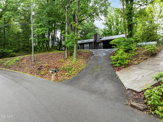 2887 Pine Haven Dr, Sevierville, TN 37862 - ranch-style house featuring asphalt driveway and a chimney