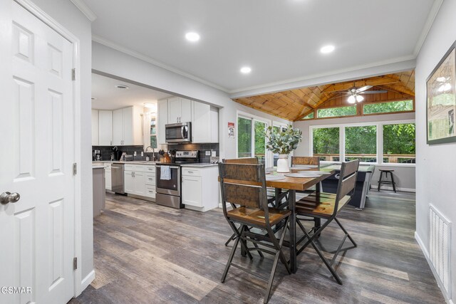 2887 Pine Haven Dr, Sevierville, TN 37862 - dining room featuring a ceiling fan, lofted ceiling, crown molding, dark wood-style floors, and recessed lighting