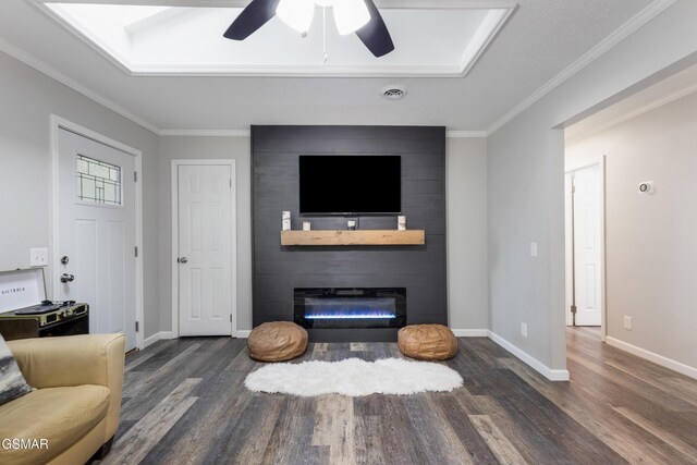 2887 Pine Haven Dr, Sevierville, TN 37862 - living area featuring wood finished floors, a ceiling fan, a fireplace, ornamental molding, and baseboards