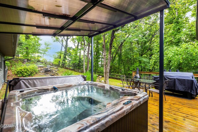 2887 Pine Haven Dr, Sevierville, TN 37862 - wooden deck with a hot tub and a grill