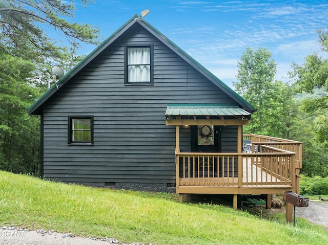 view of home's exterior featuring metal roof, crawl space, and a wooden deck