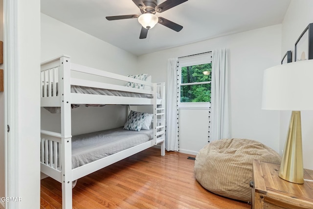 bedroom with visible vents, wood finished floors, and a ceiling fan