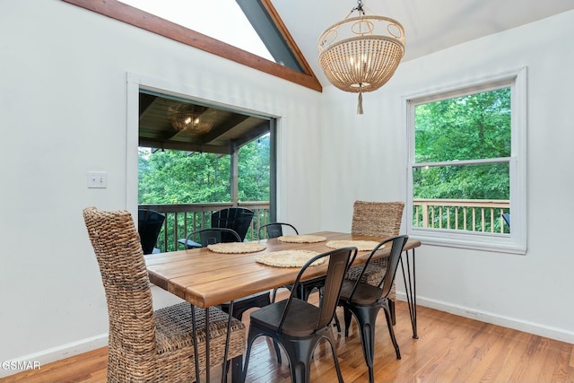 dining room featuring baseboards, light wood-style flooring, and a healthy amount of sunlight