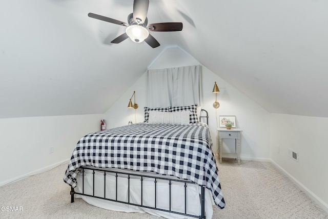 carpeted bedroom with lofted ceiling, ceiling fan, visible vents, and baseboards