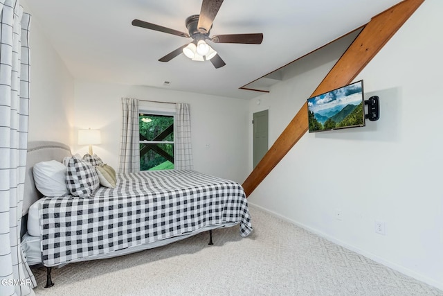 carpeted bedroom with ceiling fan and baseboards