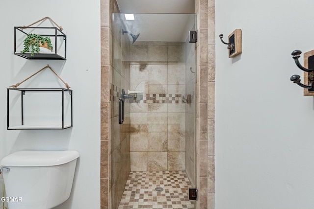 bathroom with a stall shower and toilet