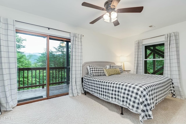 bedroom with ceiling fan, carpet, and access to exterior