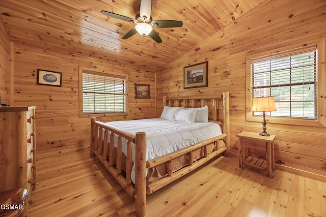 1830 Blue Tick Way, Sevierville, TN 37876 - bedroom featuring vaulted ceiling, light wood-style flooring, and wood walls