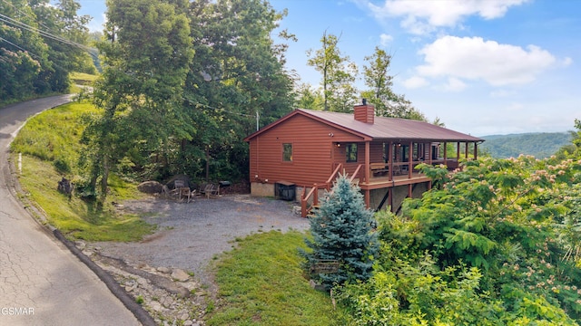 1830 Blue Tick Way, Sevierville, TN 37876 - view of side of home with a chimney, log veneer siding, stairway, and a metal roof