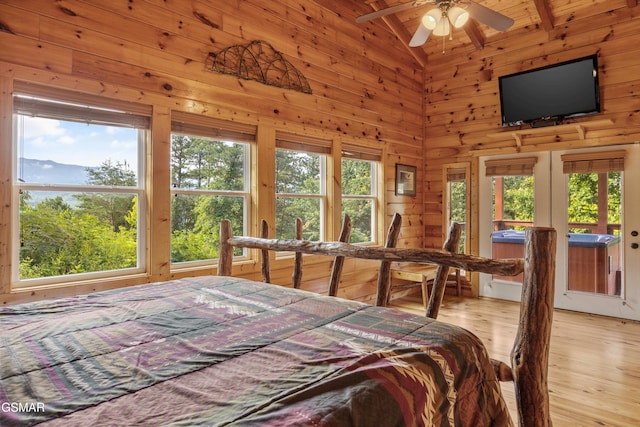 1830 Blue Tick Way, Sevierville, TN 37876 - bedroom featuring multiple windows, light wood finished floors, high vaulted ceiling, wood walls, and access to exterior