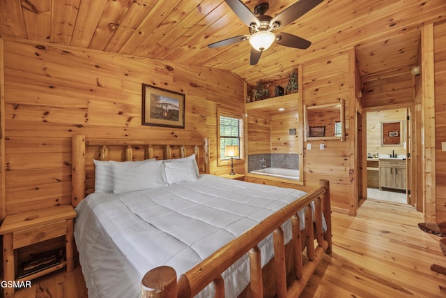 1830 Blue Tick Way, Sevierville, TN 37876 - bedroom with vaulted ceiling, wood walls, light wood finished floors, wood ceiling, and ensuite bath