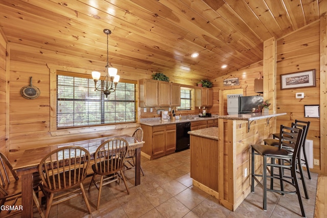1830 Blue Tick Way, Sevierville, TN 37876 - kitchen featuring black dishwasher, vaulted ceiling, fridge, wooden walls, and a peninsula