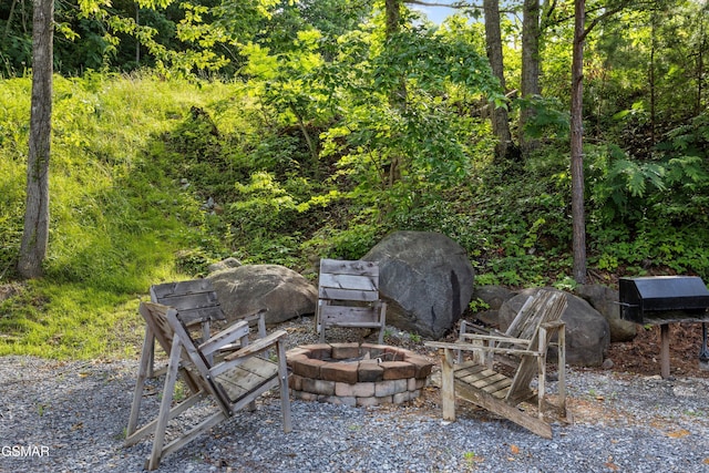1830 Blue Tick Way, Sevierville, TN 37876 - view of patio with an outdoor fire pit and a forest view