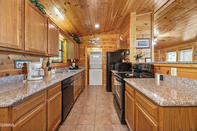 1830 Blue Tick Way, Sevierville, TN 37876 - kitchen with black appliances, vaulted ceiling, healthy amount of natural light, wooden walls, and a peninsula