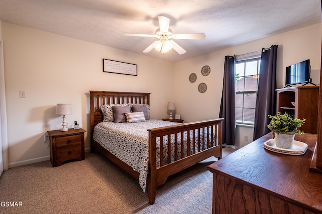 carpeted bedroom with baseboards and ceiling fan