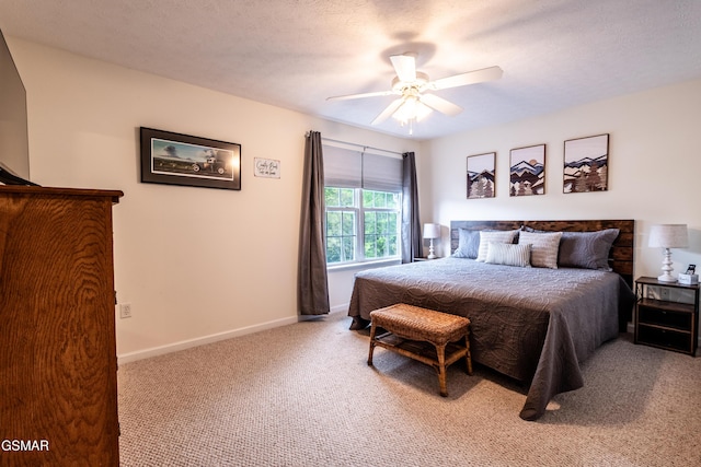 carpeted bedroom with ceiling fan and baseboards