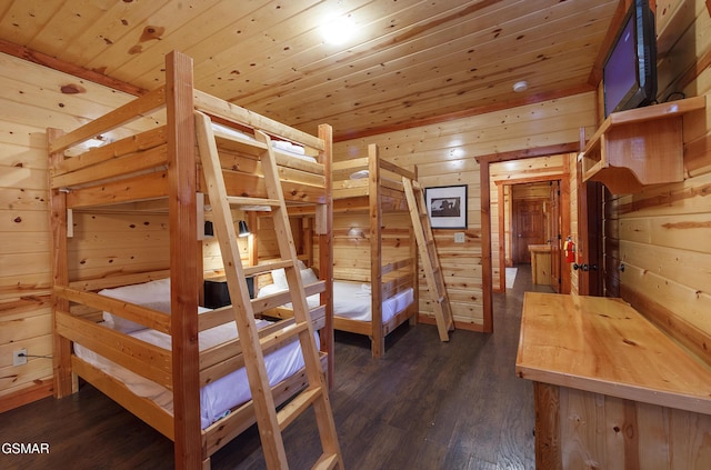 bedroom featuring wood ceiling, wooden walls, and dark hardwood / wood-style floors