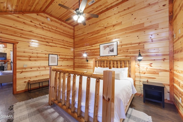 bedroom featuring dark hardwood / wood-style flooring, vaulted ceiling, and wood walls