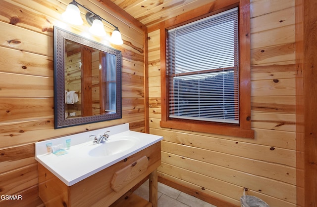 bathroom with vanity, tile patterned floors, and wood walls