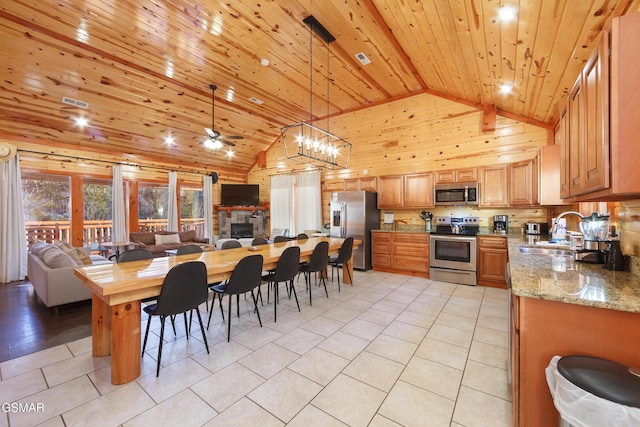 dining area featuring sink, light tile patterned floors, wooden ceiling, and high vaulted ceiling