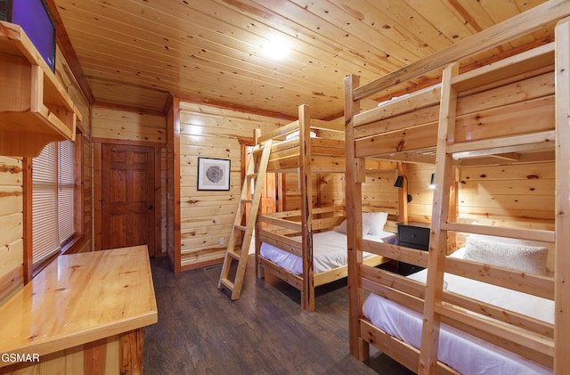 bedroom featuring wooden walls, wooden ceiling, and dark hardwood / wood-style flooring