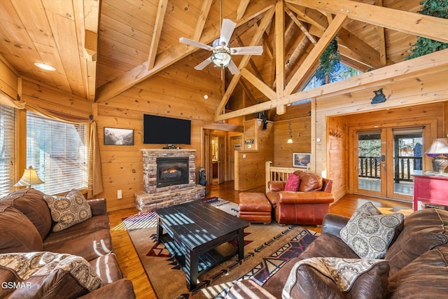 living room featuring hardwood / wood-style floors, wood ceiling, beamed ceiling, wooden walls, and high vaulted ceiling