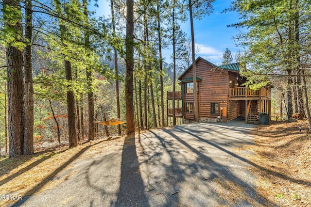 view of property exterior with a wooden deck