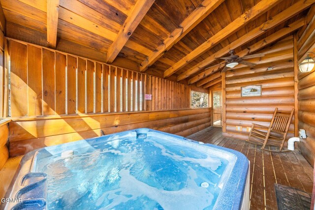 bedroom with dark wood-type flooring, wooden ceiling, log walls, and vaulted ceiling with beams