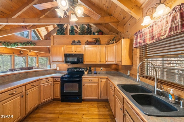 kitchen with black appliances, sink, ceiling fan, light hardwood / wood-style flooring, and beam ceiling