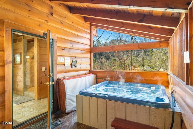 sunroom / solarium featuring vaulted ceiling with beams, a hot tub, and wood ceiling