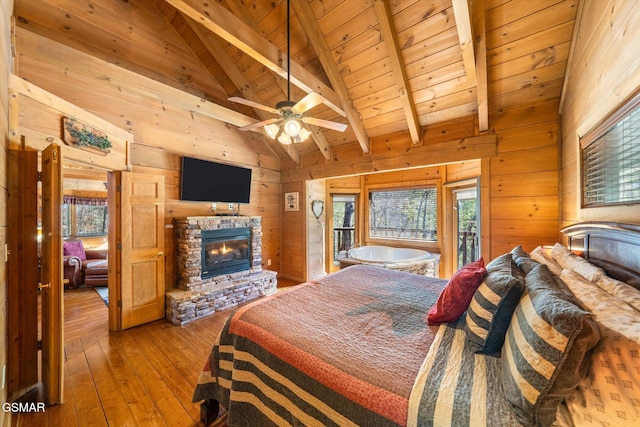 bedroom featuring wood walls, wooden ceiling, access to outside, and beamed ceiling