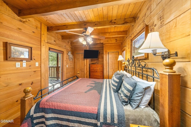 bedroom with access to exterior, beamed ceiling, wood ceiling, and wooden walls