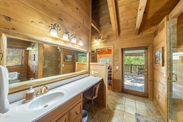 bathroom with a shower with door, wooden walls, wooden ceiling, tile patterned floors, and vanity