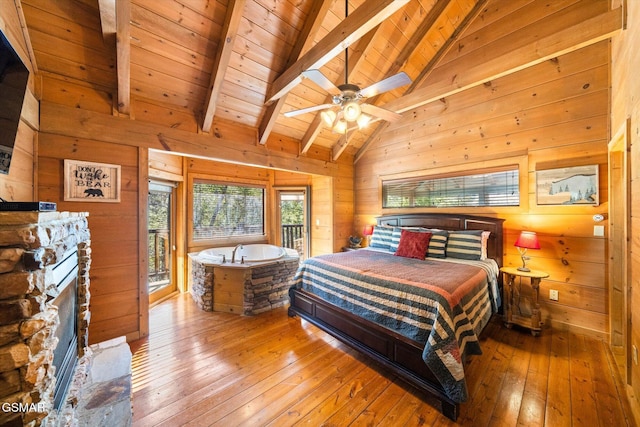 bedroom with wooden ceiling, access to exterior, beam ceiling, and wooden walls