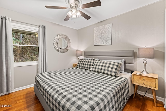 bedroom featuring dark hardwood / wood-style flooring and ceiling fan