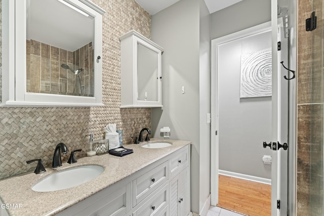 bathroom featuring vanity and decorative backsplash