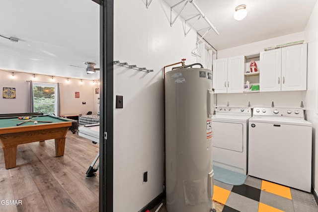 laundry room with washer and clothes dryer, cabinets, billiards, water heater, and light hardwood / wood-style floors