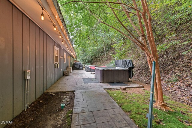 exterior space featuring grilling area and a hot tub