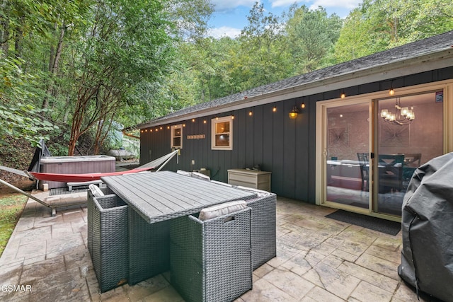 view of patio / terrace with area for grilling and a hot tub