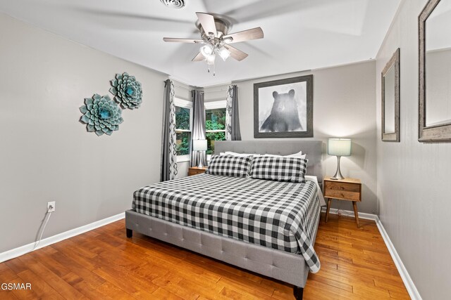 bedroom with hardwood / wood-style flooring and ceiling fan